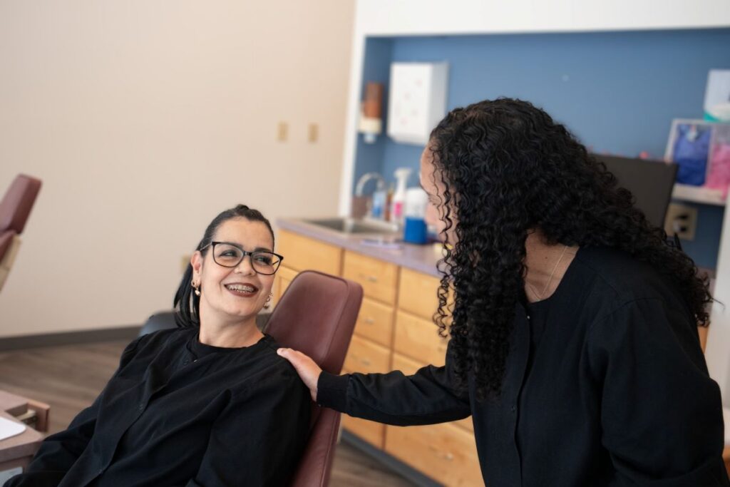 Two individuals in a clinical setting.