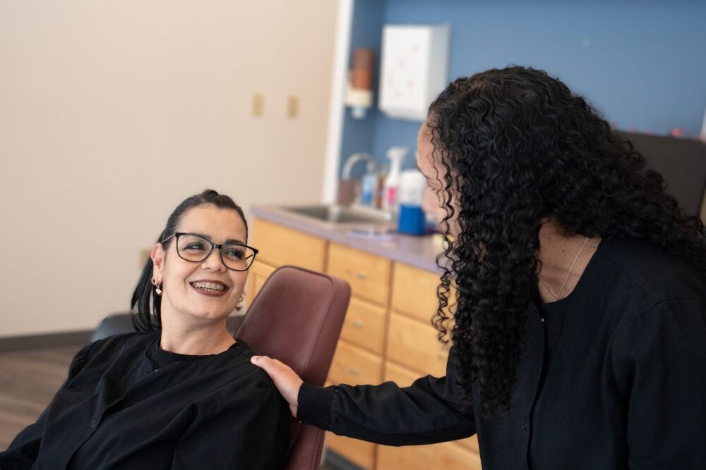 Two individuals in a clinical setting.